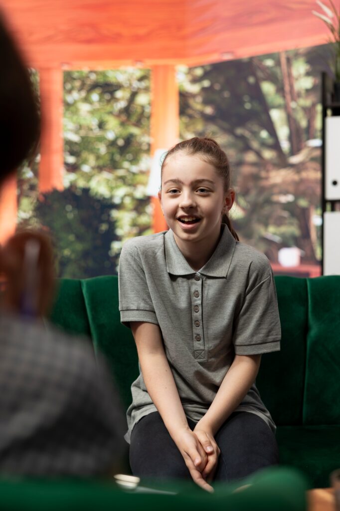 Psychologist listens to girl at counseling session dealing with anxiety